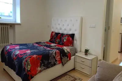 a small bedroom with a bed and a night stand at Kaunas Downtown Apartments in Kaunas