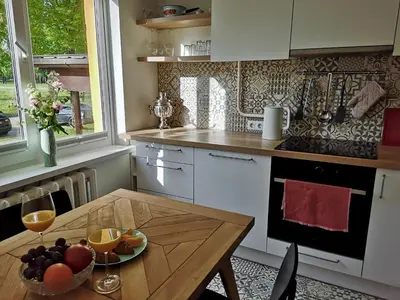 a kitchen with a table with a bowl of fruit on it at Homely apartment in Kėdainiai in Kėdainiai