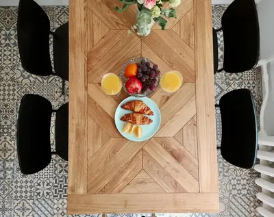 a table with a plate of fruit and two glasses of orange juice at Homely apartment in Kėdainiai in Kėdainiai