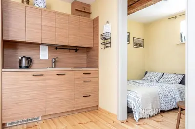 a small bedroom with a bed and a sink at Angel House Vilnius, 6 in Vilnius
