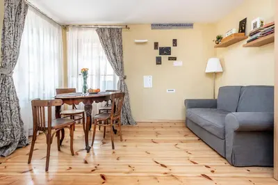a living room with a table and a couch at Angel House Vilnius, 6 in Vilnius