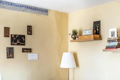 a room with a lamp and pictures on the wall at Angel House Vilnius, 6 in Vilnius