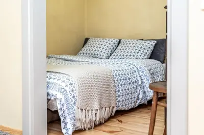 a bedroom with a bed with blue and white sheets at Angel House Vilnius, 6 in Vilnius
