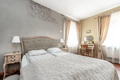 a bedroom with a bed and a table with a mirror at Angel House Vilnius, 5 in Vilnius