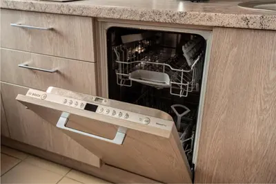 a dishwasher with its door open in a kitchen at Lovely apartment in the city center in Kaunas
