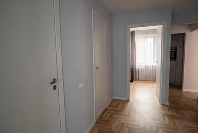 an empty room with a door and a wooden floor at Lovely apartment in the city center in Kaunas