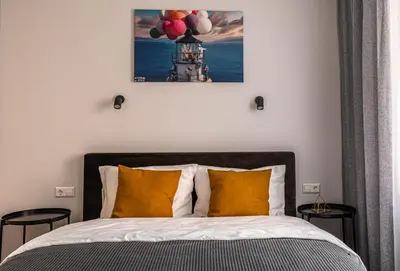 a bedroom with a bed with two chairs and balloons at Lovely apartment in the city center in Kaunas