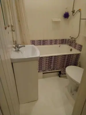 a bathroom with a sink and a toilet and a tub at Saint Stephen Old Town Apartment in Vilnius