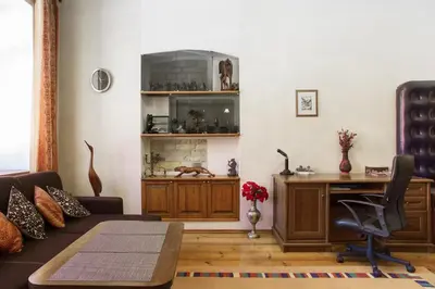 a living room with a couch and a desk at Saint Stephen Old Town Apartment in Vilnius
