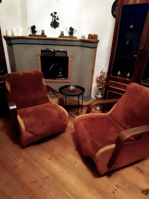 a living room with two chairs and a fireplace at Saint Stephen Old Town Apartment in Vilnius