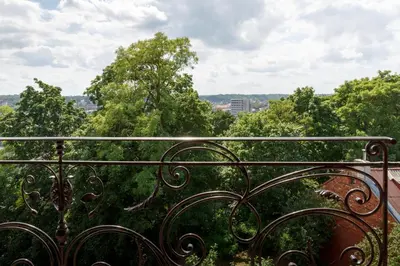 an iron fence with trees in the background at Heritage Boutique 'Green Hill' in Kaunas