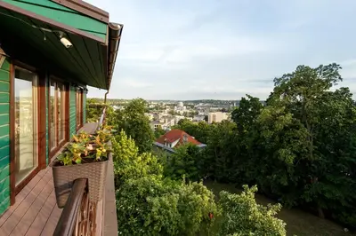 a balcony of a house with flowers on it at Heritage Boutique 'Green Hill' in Kaunas
