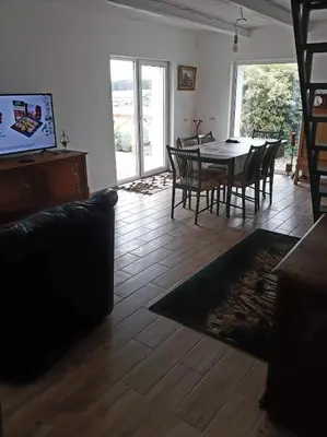 a living room with a dining room table and chairs at Kaimo Vila “Padange” in Kančėnai