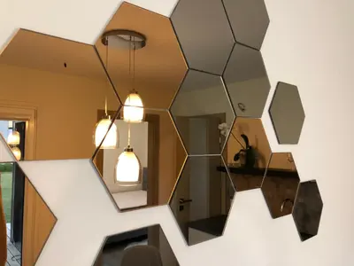 a large mirror hanging on a wall in a room at Eden House in Druskininkai