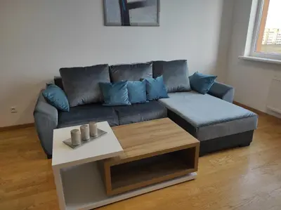 a living room with a couch and a coffee table at Klaipėdos 99 Apartamentai in Panevėžys