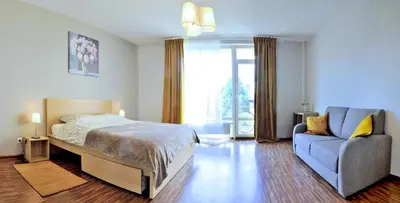a bedroom with a bed and a chair and a window at Kaminkelio apartment 44 in Vilnius
