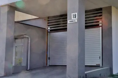 a building with a garage door with the number ten at Kaminkelio apartment 44 in Vilnius