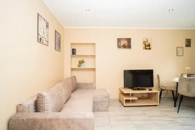 a living room with a couch and a television at Chill&Go Premium in Kaunas