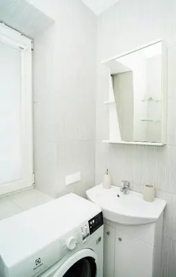 a white laundry room with a washing machine and a sink at Chill&Go Premium in Kaunas