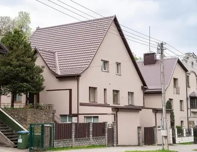 a white house with a black roof at Chill&Go Premium in Kaunas