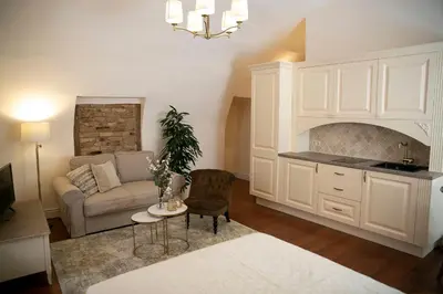 a living room with a couch and a table at Heart of OLD TOWN - St. Ann apartment in Vilnius