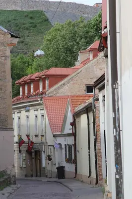 a group of buildings on a street with mountains in the background at Heart of OLD TOWN - St. Ann apartment in Vilnius
