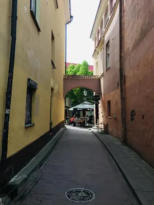 an alley with an archway between two buildings at Heart of OLD TOWN - St. Ann apartment in Vilnius