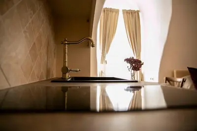 a kitchen counter with a sink and a window at Heart of OLD TOWN - St. Ann apartment in Vilnius