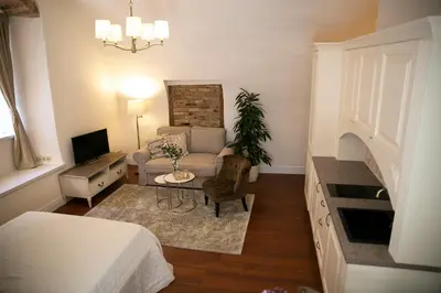 a small living room with a bed and a couch at Heart of OLD TOWN - St. Ann apartment in Vilnius