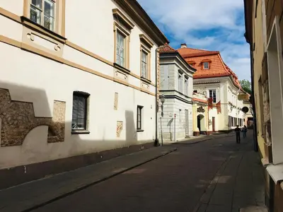 an empty street in a city with buildings at Heart of OLD TOWN - St. Ann apartment in Vilnius