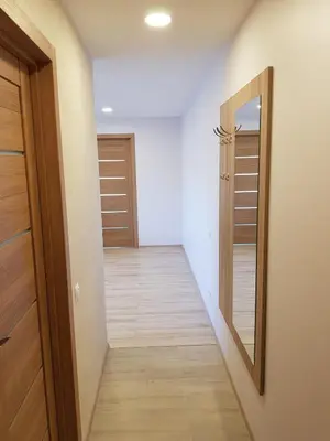 a hallway with a door and a mirror at Vilniaus 123 in Šiauliai