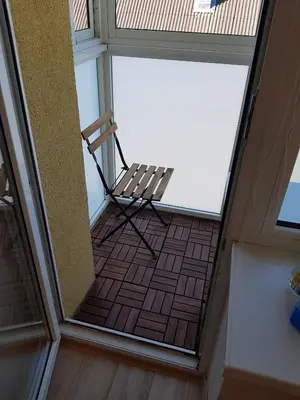 a empty chair sitting on the balcony of a house at Vilniaus 123 in Šiauliai