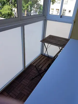 a empty bench in a room with windows at Vilniaus 123 in Šiauliai