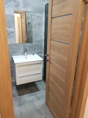 a bathroom with a white sink and a mirror at Vilniaus 123 in Šiauliai
