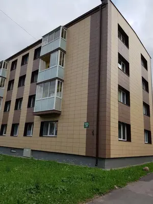 a large brick building with windows on the side of it at Vilniaus 123 in Šiauliai