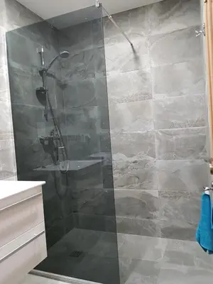 a shower with a glass door in a bathroom at Vilniaus 123 in Šiauliai