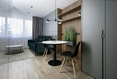 a living room with a table and a couch at City Center Apartment in Siauliai in Šiauliai