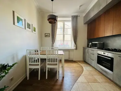 a kitchen with a table and chairs in a kitchen at Very Vilnius Stikliu street in Vilnius