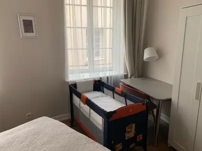 a bedroom with a desk and a bed and a table at Very Vilnius Stikliu street in Vilnius