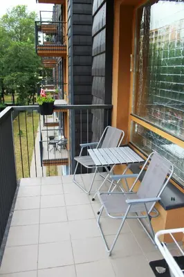 two chairs and a table on a balcony at Ruta Marija in Druskininkai