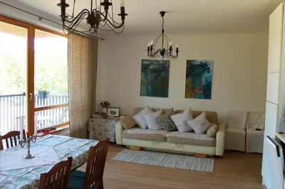a living room with a couch and a table at Ruta Marija in Druskininkai