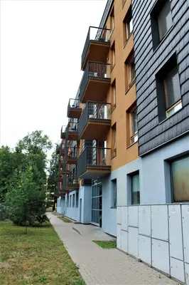 an empty sidewalk next to a tall building at Ruta Marija in Druskininkai