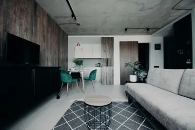 a living room with a couch and a table at ERTA Anykščių Namai in Anykščiai