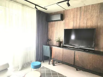 a living room with a large flat screen tv on a wall at ERTA Anykščių Namai in Anykščiai