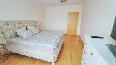 a small bedroom with a bed and a television at Julia apartments next to AQUA PARK in Druskininkai