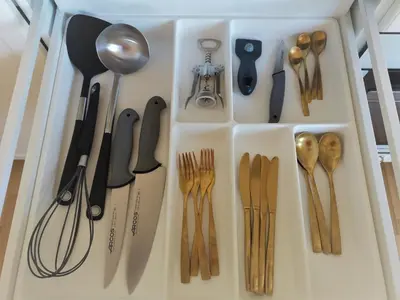 a drawer filled with lots of utensils at Julia apartments next to AQUA PARK in Druskininkai