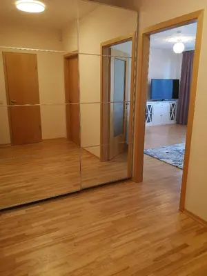 a room with glass doors and a room with a television at Julia apartments next to AQUA PARK in Druskininkai