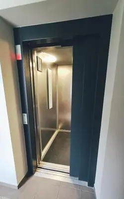 a door to a walk in shower in a room at Julia apartments next to AQUA PARK in Druskininkai