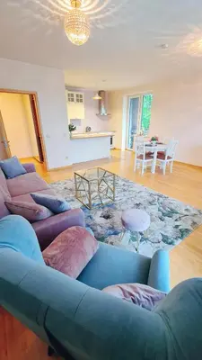 a living room with a couch and a table at Julia apartments next to AQUA PARK in Druskininkai