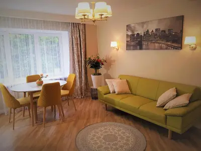 a living room with a green couch and a table at TIP TOP in Šiauliai